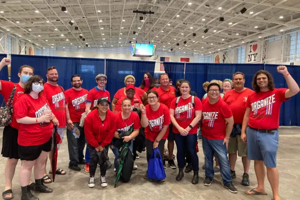 A large group of CSD workers wearing red CWA tshirts at the Syracuse Labor Day March
