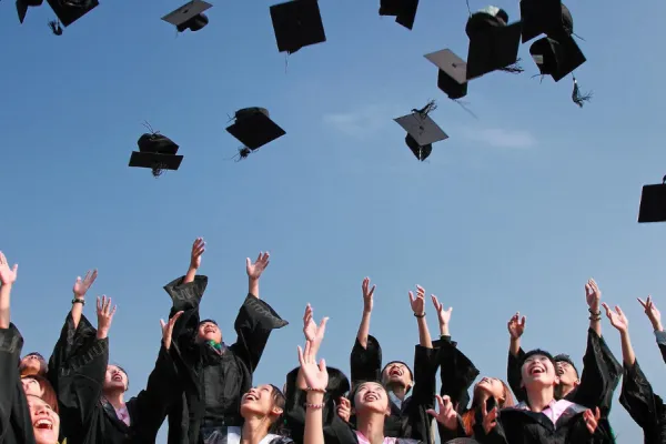 Pic of graduates throwing caps in the air