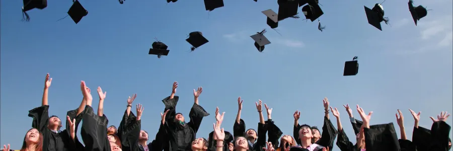 Pic of graduates throwing caps in the air