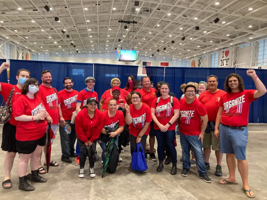 A large group of CSD workers wearing red CWA tshirts at the Syracuse Labor Day March