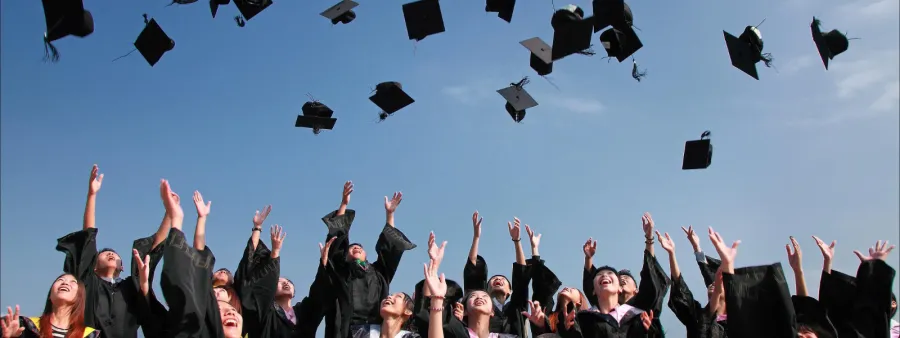 Pic of graduates throwing caps in the air